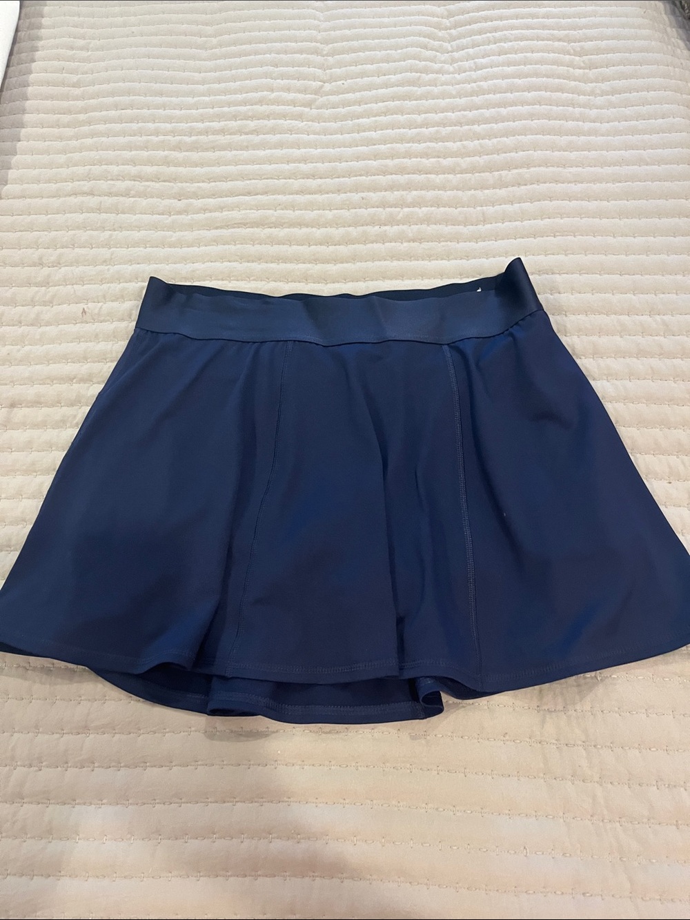 Navy Athletic Skort with Built-In Shorts, flare styling and elastic waistband.
